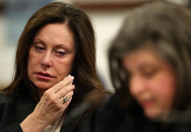 Bridgette Denison wipes away tears as her sister-in-law Lauren Denison testifies in a Senate Judiciary hearing at the Legislative Building in Carson City, Nev., on Thursday, March 14, 2013. The family is urging lawmakers to support a bill that would require anyone arrested for a felony to submit a DNA sample. The bill, commonly known as Brianna's Law, is named after Bridgette Denison's 19-year-old daughter who was murdered in Reno, Nev., in 2008. 