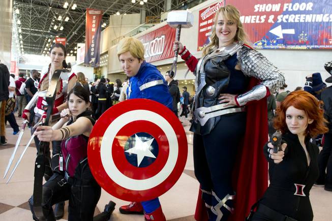 Costumed attendees pose on the floor of the New York Comic-Con fan convention in New York, Saturday, Oct. 13, 2012  in New York.  