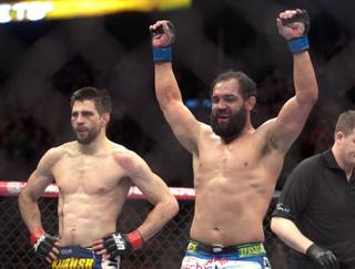 Johny Hendricks from the United States, right, celebrates following his UFC 158 welterweight fight with Carlos Condit, left, also from the United States in Montreal, Saturday, March 16, 2013.(AP Photo/The Canadian Press, Graham Hughes)