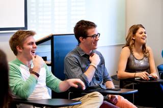 Iowa students Storm Vaske (from left),.Drew O'Bleness, and Chelsea Gaylord crack up laughing while collectively sharing daily stories with their classmates during their morning meeting for their college course 