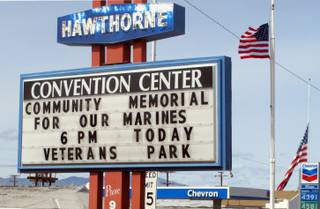 A sign telling residents about a memorial service is posted at the Convention Center in Hawthorne, Nev., near the Hawthorne Army Depot on Tuesday, March 19, 2013, where seven Marines were killed and several others seriously injured in a training accident Monday night, about 150 miles southeast of Reno in Nevada's high desert.