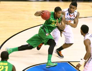 Oregon forward Carlos Emory drives against Oklahoma State forward Le'Bryan Nash during their second round game at the NCAA Basketball Tournament Thursday, March 21, 2013 at the HP Pavilion in San Jose, Calif.