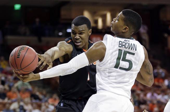 Miami's Rion Brown (15) and Pacific's Khalil Kelley go after a rebound during the first half of a second-round game of the NCAA college basketball tournament Friday, March 22, 2013, in Austin, Texas.