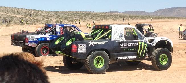 Trucks roll to the starting line of the Mint 400 off-road race on Saturday, March 23, 2013, near Las Vegas.