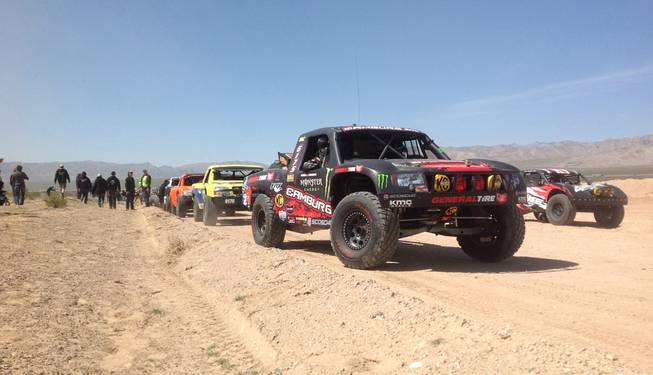 Competitors stage for the start of the Mint 400 off-road race Saturday, March 23, 2013, near Las Vegas. The event drew more than 1,000 entrants in 19 pro classes and two sportsman classes.