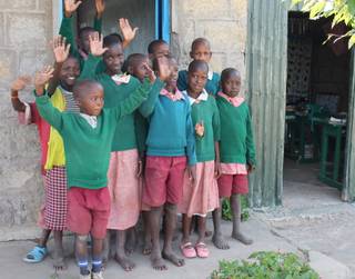 Children who attend Oloibormurt Primary School in Kenya's Maasai Mara region wave goodbye to a visiting party from the U.S., which included Moreno brothers Frankie, Tony and Ricky.