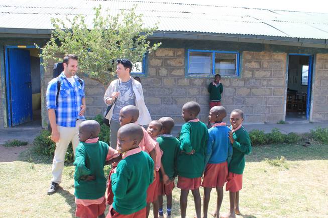 Frankie and Tony Moreno are welcomed by school children at Oloibormurt Primary School in Kenya's Maasai Mara region.