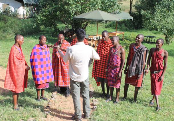 Frankie Moreno directs a group of Maasai tribesmen who work at Porini Mara Camp for a music video for his song 