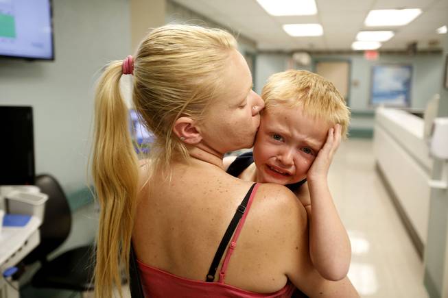 Angela comforts her son Kaleb as they leave University Medical Center in Las Vegas, where they were visiting Kaleb's dad Tom, on Thursday, March 28, 2013. According to the National Center of Family Homelessness, there are over 1500 children homeless in Nevada.
