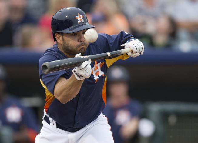 Houston Astros' Jose Altuve attempts to bunt for a base hit during the second inning of an exhibition spring training baseball game against the New York Mets on Wednesday, March 20, 2013, in Kissimmee, Fla.