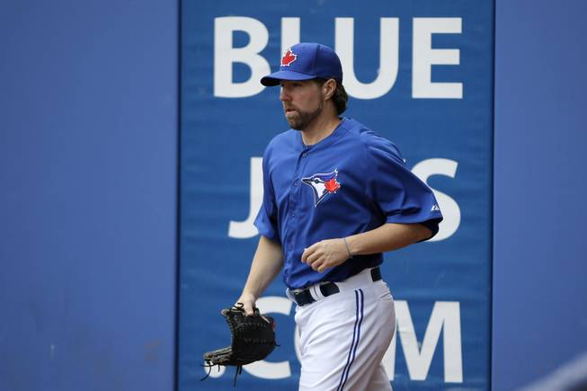 Toronto Blue Jays' R.A. Dickey runs onto the field for a workout at baseball spring training, Friday, Feb. 15, 2013, in Dunedin, Fla.