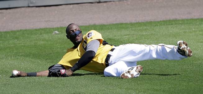 Pittsburgh Pirates left fielder Starling Marte loses his sunglasses after missing a fly ball during a baseball spring training intrasquad game, Friday, Feb. 22, 2013, in Bradenton, Fla.