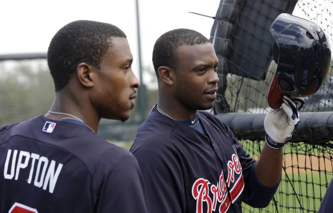 Atlanta Braves outfielder B.J. Upton (2) and his brother Justin Upton wait to bat during a spring training baseball workout Friday, Feb. 15, 2013, in Kissimmee, Fla.