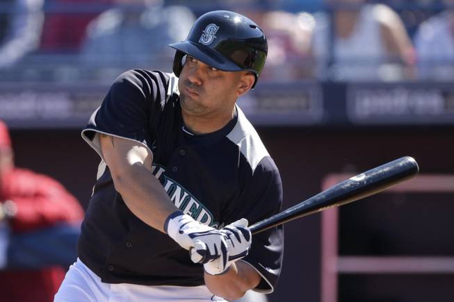 Seattle Mariners' Kendrys Morales bats during an exhibition spring training baseball game against the Los Angeles Angels Monday, Feb. 25, 2013, in Peoria, Ariz. 