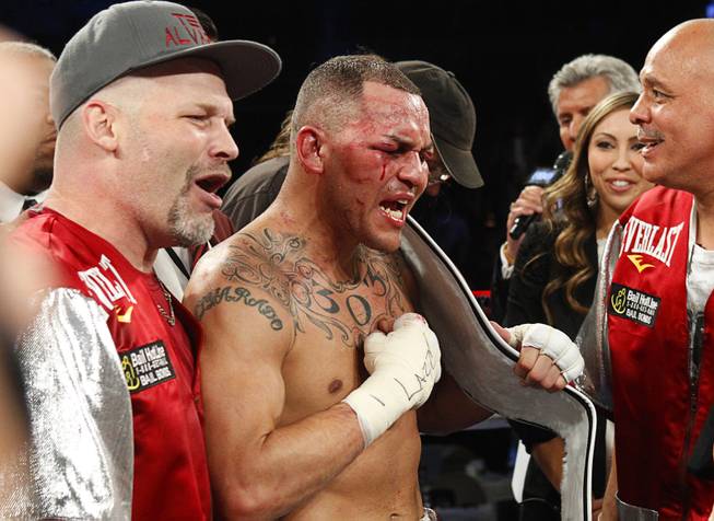 Mike Alvarado, center, celebrates his victory over Brandon Rios following a super lightweight bout for an interim 140lb. WBO title at the Mandalay Bay Events Center Saturday, March 30, 2013. The fight was a rematch to a Oct. 13, 2012 fight  which Rios won.
