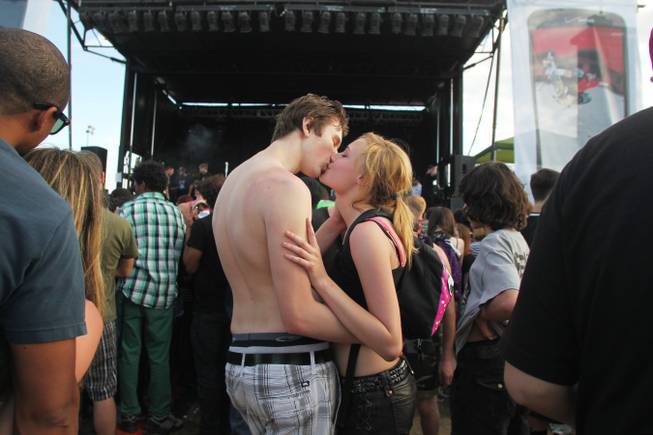 A young couple kisses while waiting for a band to start during the Extreme Thing Sports & Music Festival at Desert Breeze Park.Saturday, March 30, 2013.