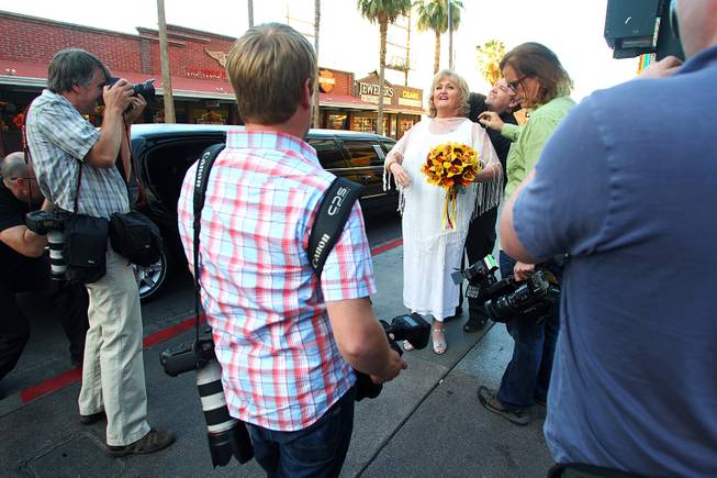 Nancy Levandowski has a wireless mic fitted by a crew from the television tabloid show "Inside Edition" before she exchanges wedding vows with Steve Keller at the Denny's restaurant on Fremont Street Wednesday, April 3, 2013.