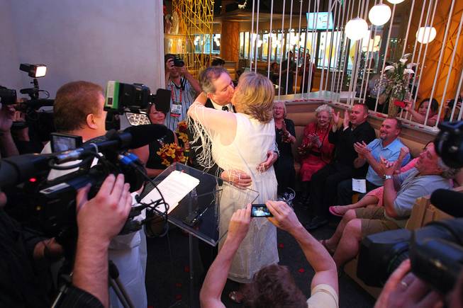 Nancy Levandowski and Steve Keller kiss after exchanging wedding vows at the Denny's restaurant on Fremont Street Wednesday, April 3, 2013.