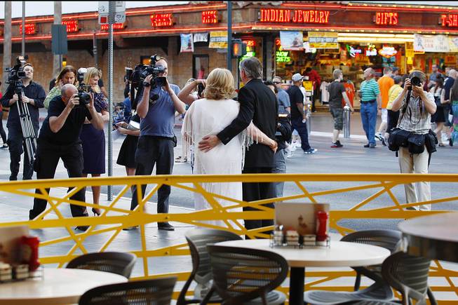 Ames, Iowa, residents Nancy Levandowski and Steve Keller have their photo taken and video shot after exchanging wedding vows at the Denny's restaurant on Fremont Street Wednesday, April 3, 2013.