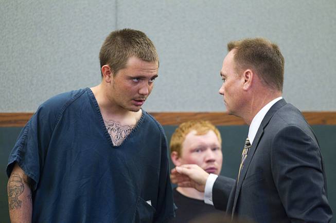 Gage James Lindsey, 18, speaks to attorney Sean Sullivan at the Regional Justice Center Thursday, April 4, 2013. Lindsey is facing charges related to the Monday accident at the Egg & I restaurant that injured 10 people.