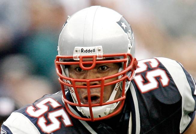 In this Oct. 7, 2007, file photo, New England Patriots linebacker Junior Seau runs with the ball after an interception during New England's 34-17 win over the Cleveland Browns in a football game at Gillette Stadium in Foxborough, Mass. A pair of wrongful-death lawsuits over the suicide of Seau have been consolidated with NFL concussion litigation in Philadelphia.