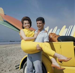 In this 1963 file photo, singer Frankie Avalon and actress Annette Funicello are seen on Malibu Beach during filming of 