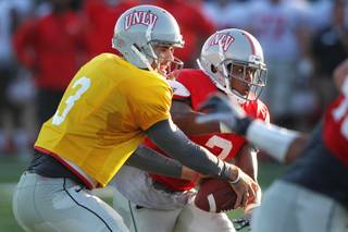 UNLV quarterback Nick Sherry hands off to Adonis Smith during their spring football game Friday, April 12, 2013.