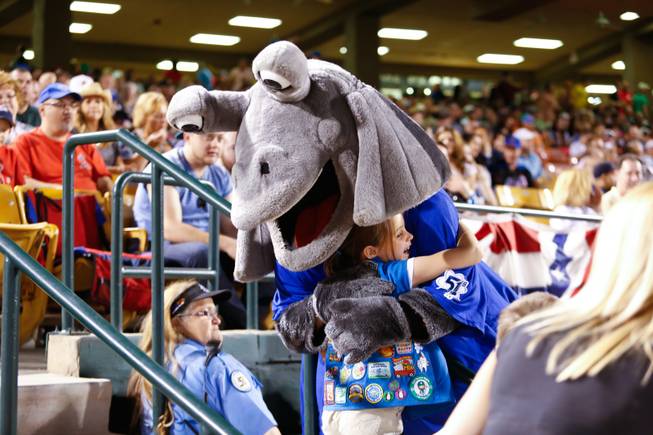 A young baseball fan recieves a hug from Cosmo during the opening game for the Las Vegas 51's against the Colorado Springs Sky Sox at Cashman Field, Friday April 12, 2013.