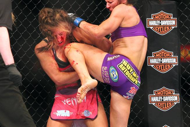 Cat Zingano pounds Miesha Tate with knees on her way to a third round TKO during their bout at The Ultimate Fighter 17 Finale Saturday, April 13, 2013 at the Mandalay Bay Events Center.