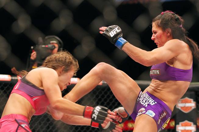 Cat Zingano lands a kick to the midsection of Miesha Tate during their bout at The Ultimate Fighter 17 Finale Saturday, April 13, 2013 at the Mandalay Bay Events Center. Zingano won with a third round TKO.