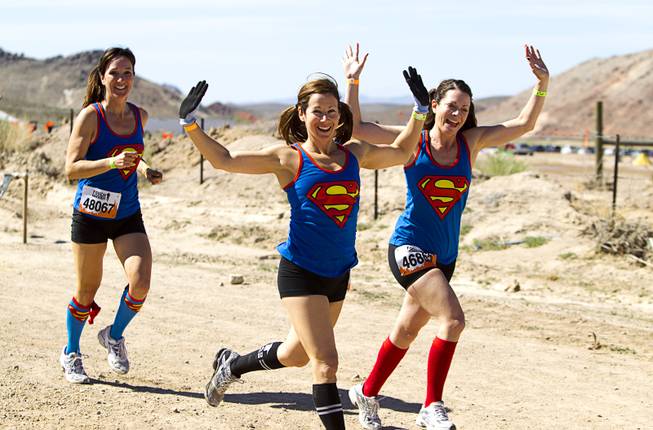 Women with matching Superman shirts start off during the Tough Mudder in Beatty, Nev. Sunday, April 14, 2013. Tough Mudder events are hardcore 10-12 mile obstacle courses designed to test all-around strength, stamina, mental grit, and camaraderie.