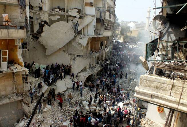 This citizen journalism image taken on Sunday, April 7, 2013, and provided by Aleppo Media Center AMC, which has been authenticated based on its contents and other AP reporting, shows Syrian citizens searching for bodies in the rubble of damaged buildings that were attacked by Syrian forces airstrikes, in the al-Ansari neighborhood of Aleppo, Syria. More than 70,000 people have died since Syria's crisis erupted in March 2011. The Syria-based Violations Documentation Center says nearly 9,000 government troops have been killed in two years of fighting between President Bashar Assad's forces and rebels trying to topple him.