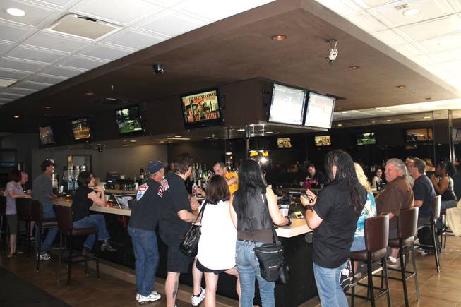 Patrons hit the bar at Gold Spike on the casino's final day of operations in downtown Las Vegas.