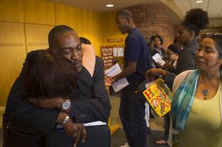 Tyrone Thompson gets a hug from Meli Pulido after he was appointed to replace expelled Nevada Assemblyman Steven Brooks during a county commission meeting at the Clark County Government Center Tuesday, April 16, 2013. Pulido was also a candidate in the selection process.