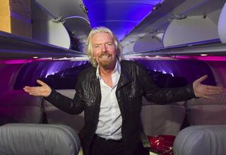 Sir Richard Branson, Virgin Group founder, stands inside a Virgin America jet as he celebrates the new Virgin America service between Los Angeles and Las Vegas after the arrival of the inaugural flight Monday, April 22, 2013, at McCarran International Airport.