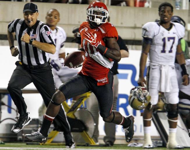 Utah wide receiver DeVonte Christopher, a Canyon Springs grad, runs with the ball in a 31-14 loss to Washington on Oct. 1, 2011, in Salt Lake City.