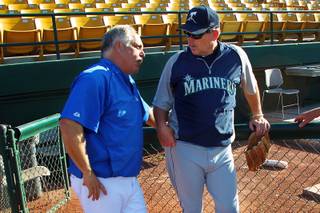 Former Mets teammates Las Vegas 51's manager Wally Backman, left, and Tacoma Rainiers hitting coach Howard Johnson talk before their game Thursday, April 25, 2013.