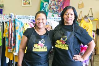 Rebeca Ferreira and Francisca Torres, both survivors of domestic violence, stand inside their thrift shop Survivor Store and Training Center, Thursday, April 25, 2013. The secondhand store helps victims of domestic violence by training them to find employment and become financially independent.