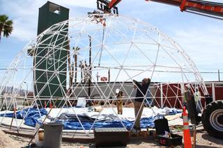 Workers install a fabric sheet on a geodesic dome that will become part of the Downtown Container Park near Seventh and Fremont streets.