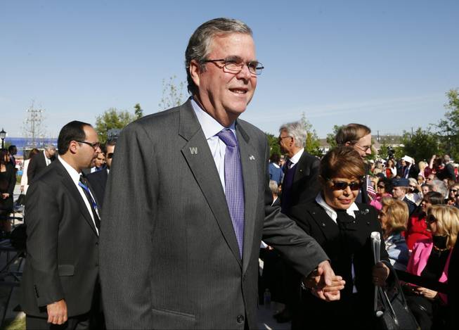 Former Florida Gov. Jeb Bush and his wife, Columba, arrive for the dedication of the George W. Bush presidential library on the campus of Southern Methodist University in Dallas, Thursday, April 25, 2013. 