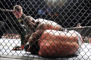 Champion Jon Jones, top, lands an elbow against Chael Sonnen during their UFC 159 light heavyweight title bout in Newark, N.J., Saturday, April 27, 2013. Jones retained his title via first-round TKO. 