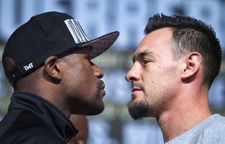 Undefeated WBC welterweight champion Floyd Mayweather Jr., left, faces off with Robert Guerrero during a news conference at the MGM Grand Wednesday, May 1, 2013. Mayweather will defend his title against Guerrero at the MGM Grand Garden Arena on Saturday.