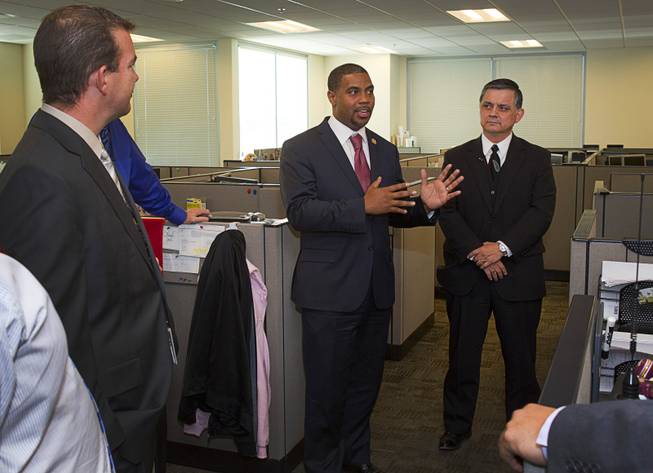 Congressman Steven Horsford (D-NV), center, talks with officials after a tour of the Southern Nevada Counter-Terrorism Center, also known as the Fusion Center, at Metro Police Headquarters Thursday, May 2, 2013. Officials at the center are concerned that budget cuts that might negatively affect its operations.