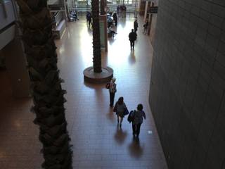 People are seen walking in the dark lobby of the Las Vegas Regional Justice Center during an afternoon power outage, Thursday, May 2, 2013.