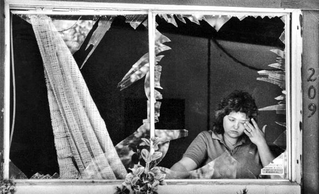 Barbara Hepworth assesses the damage to her home May 6, 1988. Windows and doors of homes and businesses nearby were shattered when two blasts destroyed the Pacific Engineering Production Company of Nevada plant May 4, 1988.