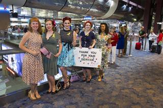 Members of Pinups for Patriots wait to welcome back World War II veterans after the first Las Vegas Honor Flight at McCarran International Airport Sunday, May 5, 2013. About 35 Southern Nevada veterans visited Baltimore and memorials in Washington D.C. Pinups for Patriots is a group that works with charities that support military causes.
