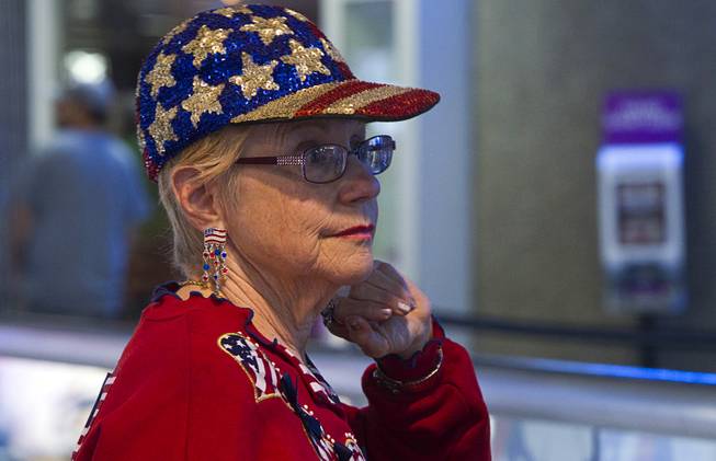 A woman, dressed in patriotic attire, waits to welcome back World War II veterans after the first Las Vegas Honor Flight at McCarran International Airport Sunday, May 5, 2013. About 35 Southern Nevada veterans visited Baltimore and memorials in Washington D.C.