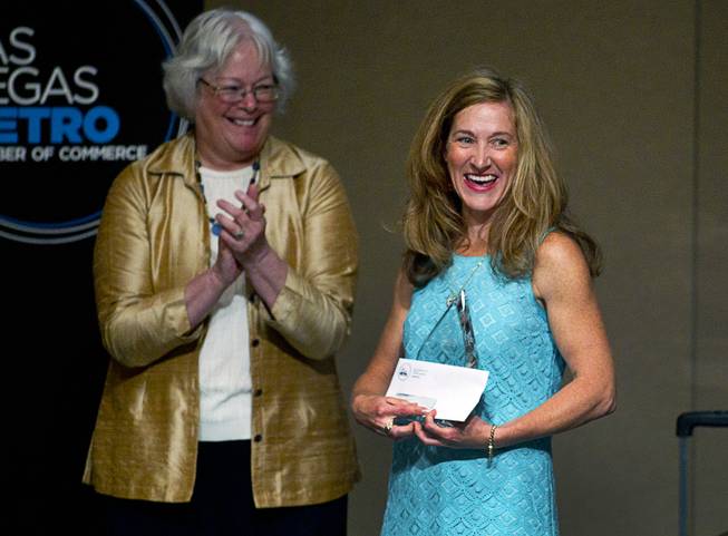 Maggie Reardon, right, a fourth grade teacher at Lucille Rogers Elementary School, is honored with an award during a Las Vegas Metro Chamber of Commerce Business Power Luncheon at the Rio Wednesday, May 8, 2013. Clark County School Board President Carolyn Edwards applauds at left. 