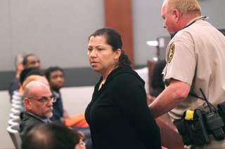 Ana Ocegueda is lead away in handcuffs after being sentenced for embezzling over $500,000 from Tom Clift and his company N.A.C. Electric Thursday, May 9, 2013.