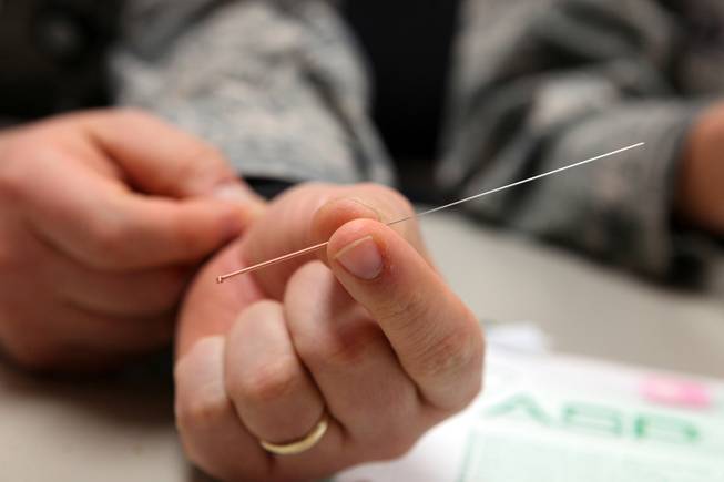 Lt. Col. (Dr.) Heather Pickett shows an acupuncture needle at Mike O'Callaghan Federal Medical Center at Nellis Air Force Base in Las Vegas on Wednesday, May 15, 2013.